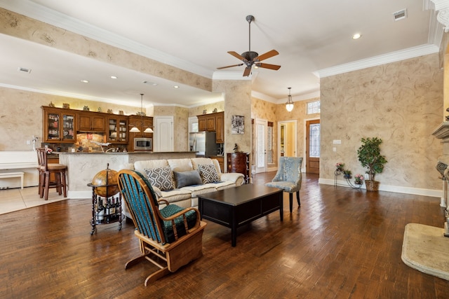 living room featuring crown molding, dark wood-type flooring, and ceiling fan