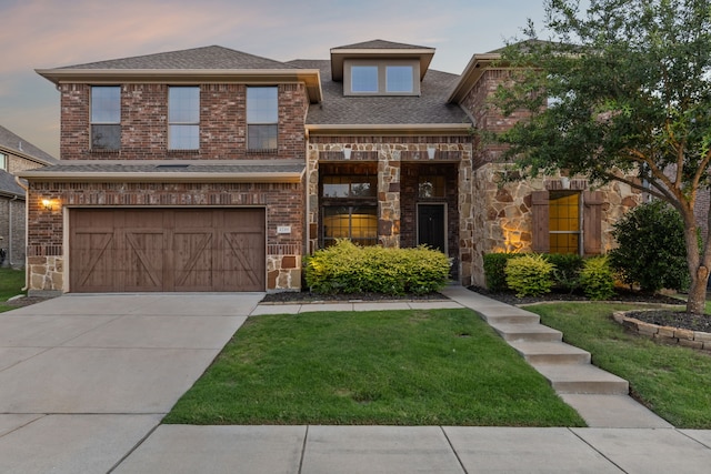 view of front of home featuring a garage and a lawn