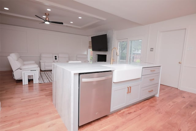 kitchen with sink, white cabinetry, light hardwood / wood-style flooring, dishwasher, and a kitchen island with sink