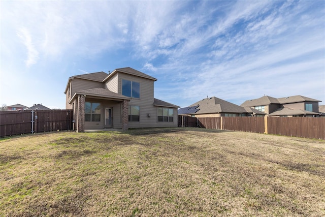 rear view of property with a yard