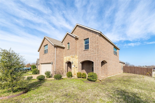 view of front property with a garage and a front yard