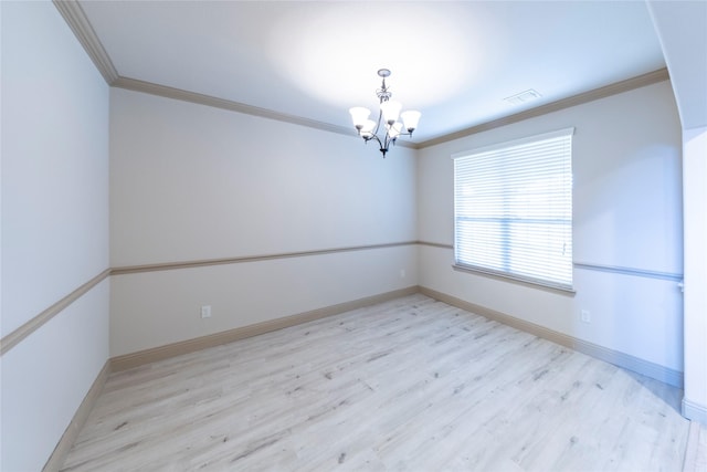 unfurnished room featuring ornamental molding, a chandelier, and light hardwood / wood-style floors