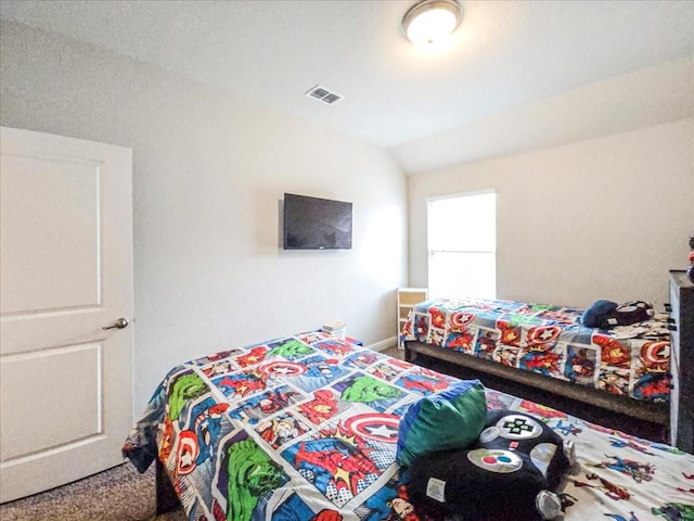 bedroom featuring lofted ceiling and visible vents