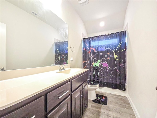 bathroom with visible vents, toilet, shower / bath combo, vanity, and baseboards