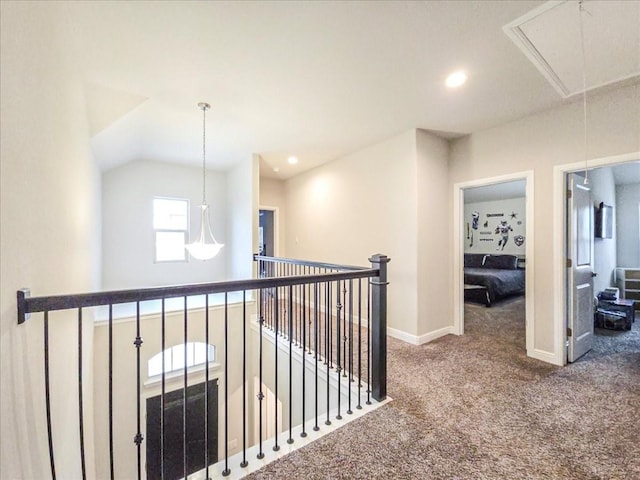 hall with recessed lighting, attic access, carpet flooring, an upstairs landing, and baseboards