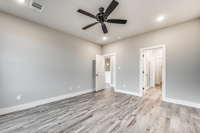 unfurnished bedroom featuring light wood-style flooring, visible vents, baseboards, and recessed lighting