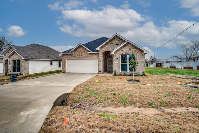 ranch-style house with an attached garage, a front yard, concrete driveway, and brick siding