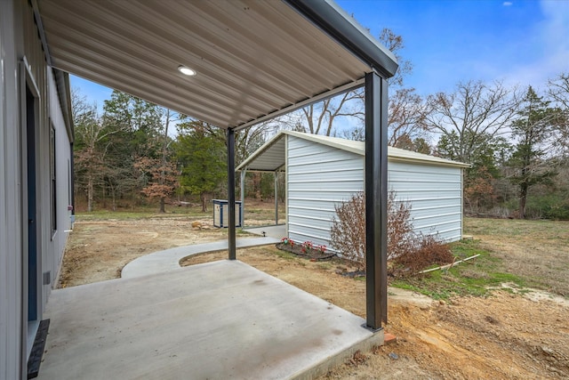 view of patio with an outbuilding