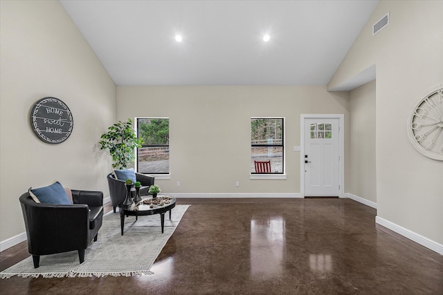 entrance foyer featuring visible vents, baseboards, finished concrete floors, high vaulted ceiling, and recessed lighting