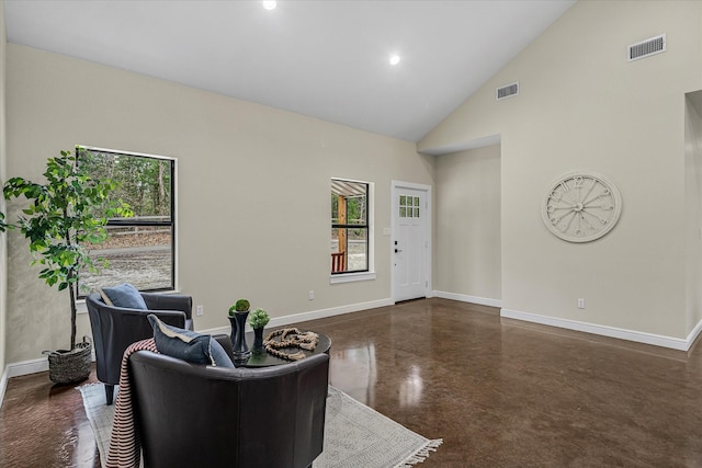 interior space with high vaulted ceiling, visible vents, and baseboards