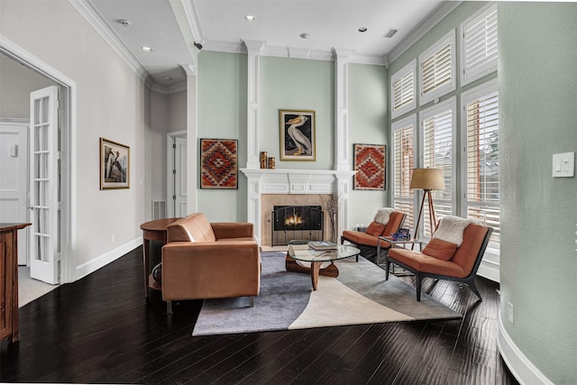 living room with crown molding, a fireplace, dark wood-type flooring, and a high ceiling