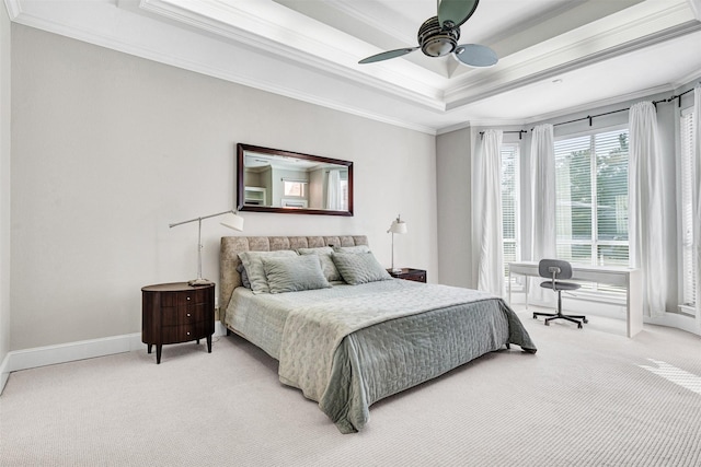 carpeted bedroom featuring ornamental molding, ceiling fan, and a tray ceiling