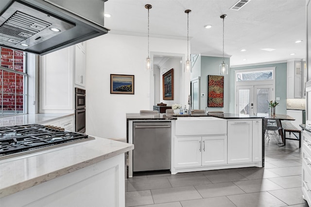 kitchen featuring white cabinetry, hanging light fixtures, stainless steel appliances, tasteful backsplash, and island exhaust hood