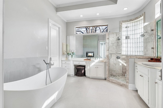 bathroom with vanity, crown molding, and plus walk in shower