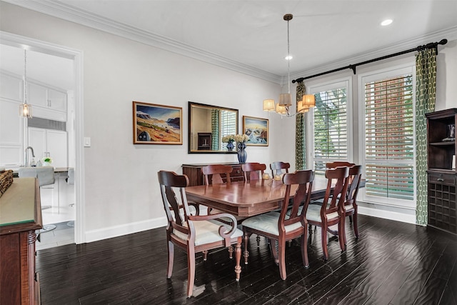 dining room with ornamental molding, dark wood-type flooring, and a chandelier