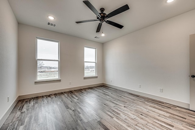 unfurnished room featuring visible vents, baseboards, a ceiling fan, light wood-style flooring, and recessed lighting