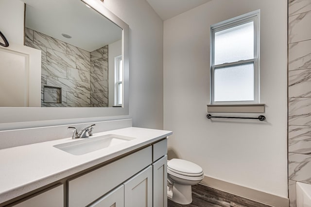 full bath featuring toilet, wood finished floors, and vanity