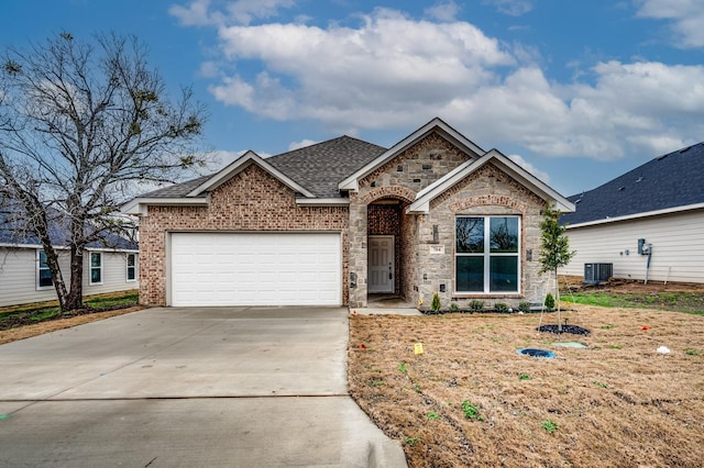 ranch-style house with an attached garage, central AC, a shingled roof, brick siding, and concrete driveway