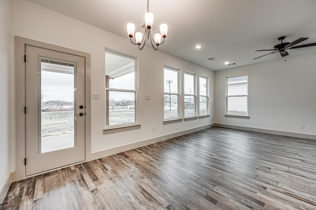 unfurnished dining area with baseboards, visible vents, wood finished floors, ceiling fan with notable chandelier, and recessed lighting