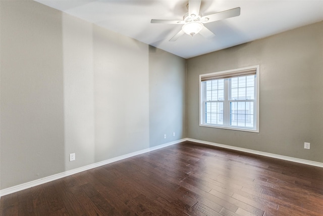 spare room with ceiling fan and dark hardwood / wood-style flooring