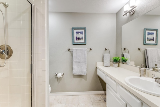 bathroom featuring an enclosed shower, vanity, and tile patterned flooring