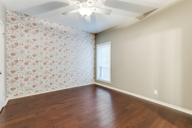 spare room featuring ceiling fan and dark hardwood / wood-style floors