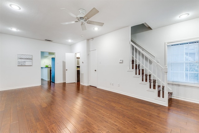 unfurnished living room featuring dark hardwood / wood-style floors and ceiling fan