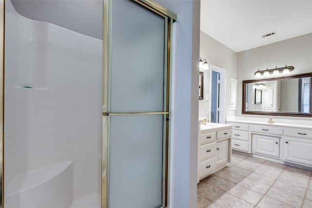 bathroom featuring vanity, an enclosed shower, and tile patterned floors