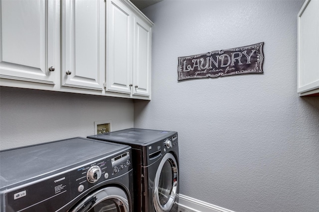 laundry room with cabinets and washer and dryer