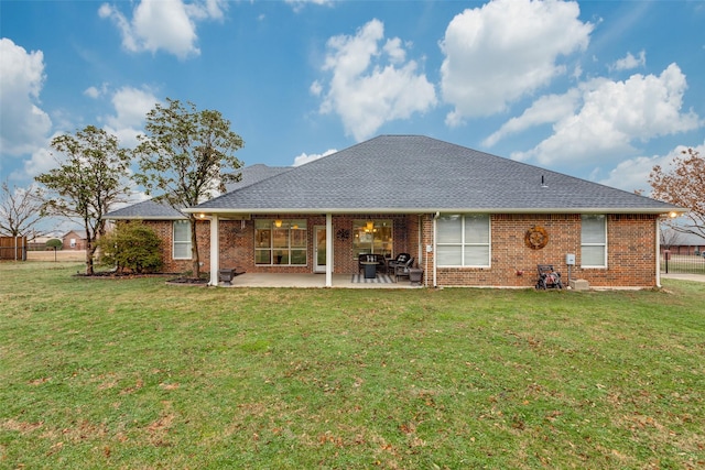 back of house with a patio area and a lawn