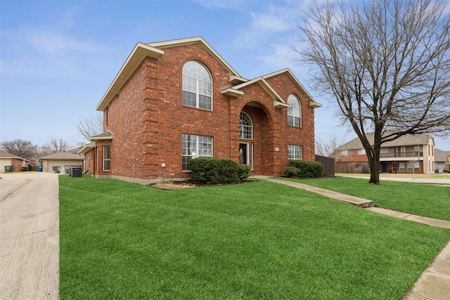 view of front of house with central AC unit and a front lawn