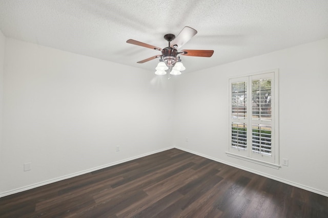 empty room with ceiling fan, dark wood-type flooring, and a textured ceiling