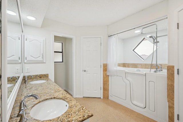 bathroom featuring vanity and a bathing tub