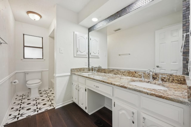 bathroom with vanity, hardwood / wood-style floors, and toilet