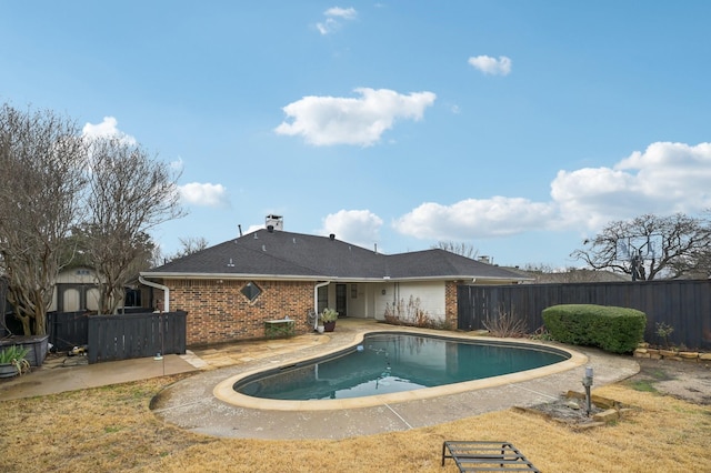 view of swimming pool featuring a yard and a patio area