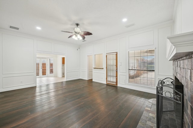 unfurnished living room with crown molding, dark wood-type flooring, and ceiling fan