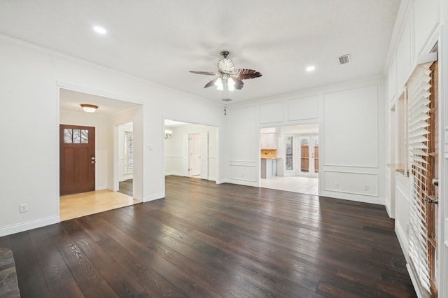 unfurnished living room with hardwood / wood-style floors, crown molding, and ceiling fan