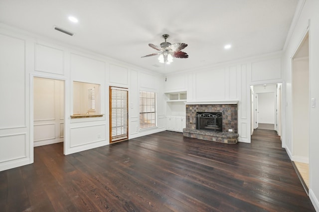 unfurnished living room featuring crown molding, ceiling fan, dark hardwood / wood-style floors, and built in shelves