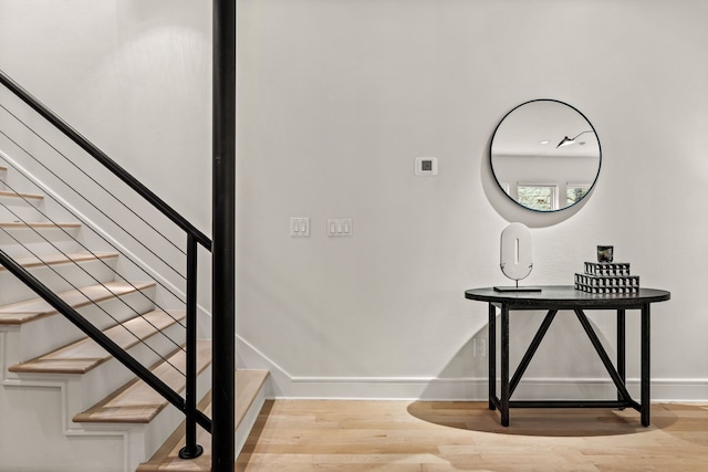 stairs featuring hardwood / wood-style flooring