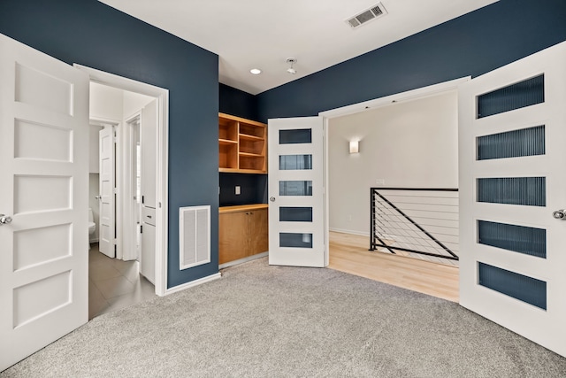 unfurnished living room with french doors and carpet floors