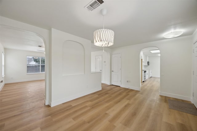 unfurnished dining area featuring light wood-type flooring