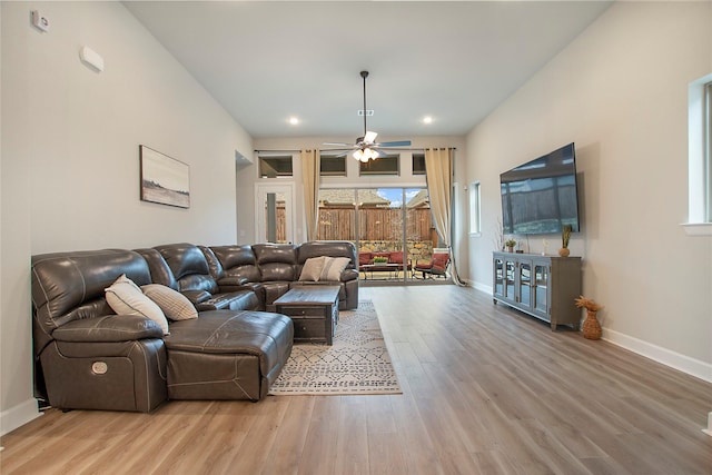 living room with ceiling fan and light hardwood / wood-style flooring