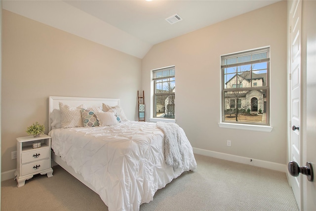 carpeted bedroom featuring lofted ceiling