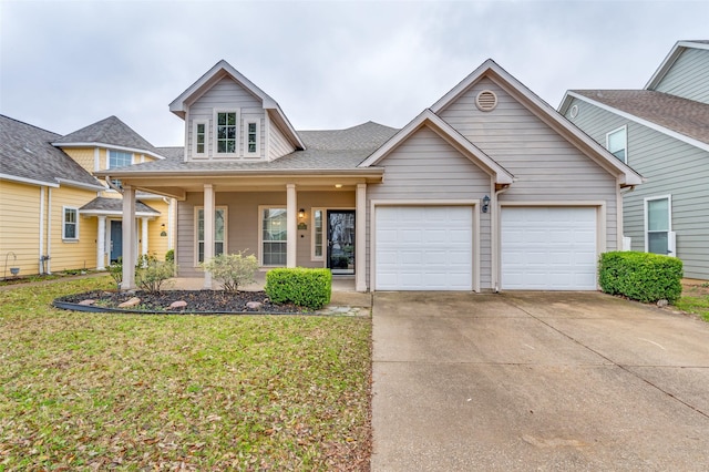 view of front of property featuring a garage, covered porch, and a front yard