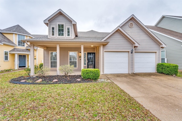 view of front facade featuring a garage, a front lawn, and covered porch