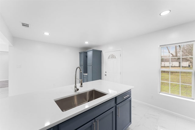 kitchen with marble finish floor, visible vents, a wealth of natural light, and a sink