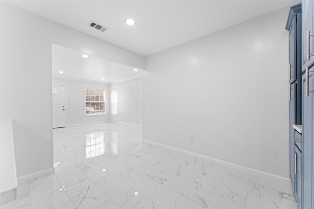 spare room featuring visible vents, marble finish floor, and baseboards