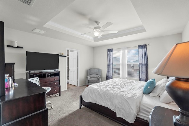 bedroom featuring ceiling fan, a raised ceiling, and light carpet