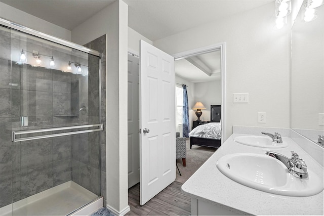 bathroom featuring hardwood / wood-style flooring, walk in shower, and vanity