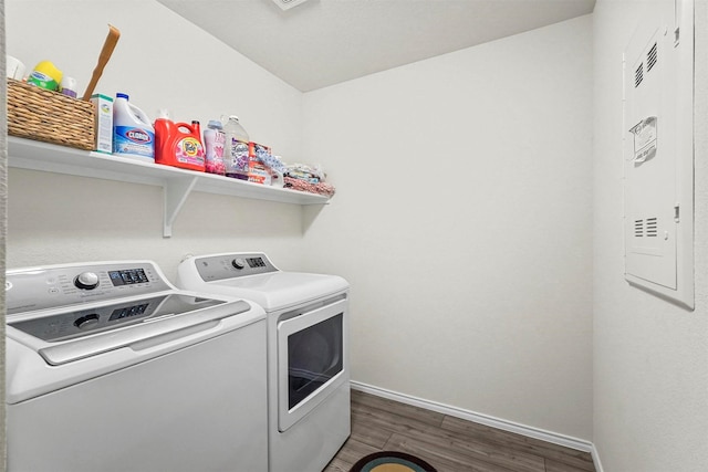 laundry area featuring washing machine and dryer and dark hardwood / wood-style flooring